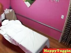 Asian massage therapist jerking her client