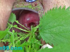 Extreme female inserting nettles into cervix and rod flowers